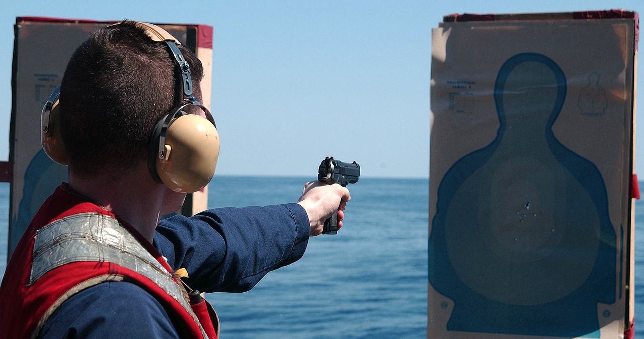 1280px-US_Navy_040417-N-7781D-057_Ens._Michael_Smith_shoots_a_9mm_pistol_during_a_pistol_qualification_shoot